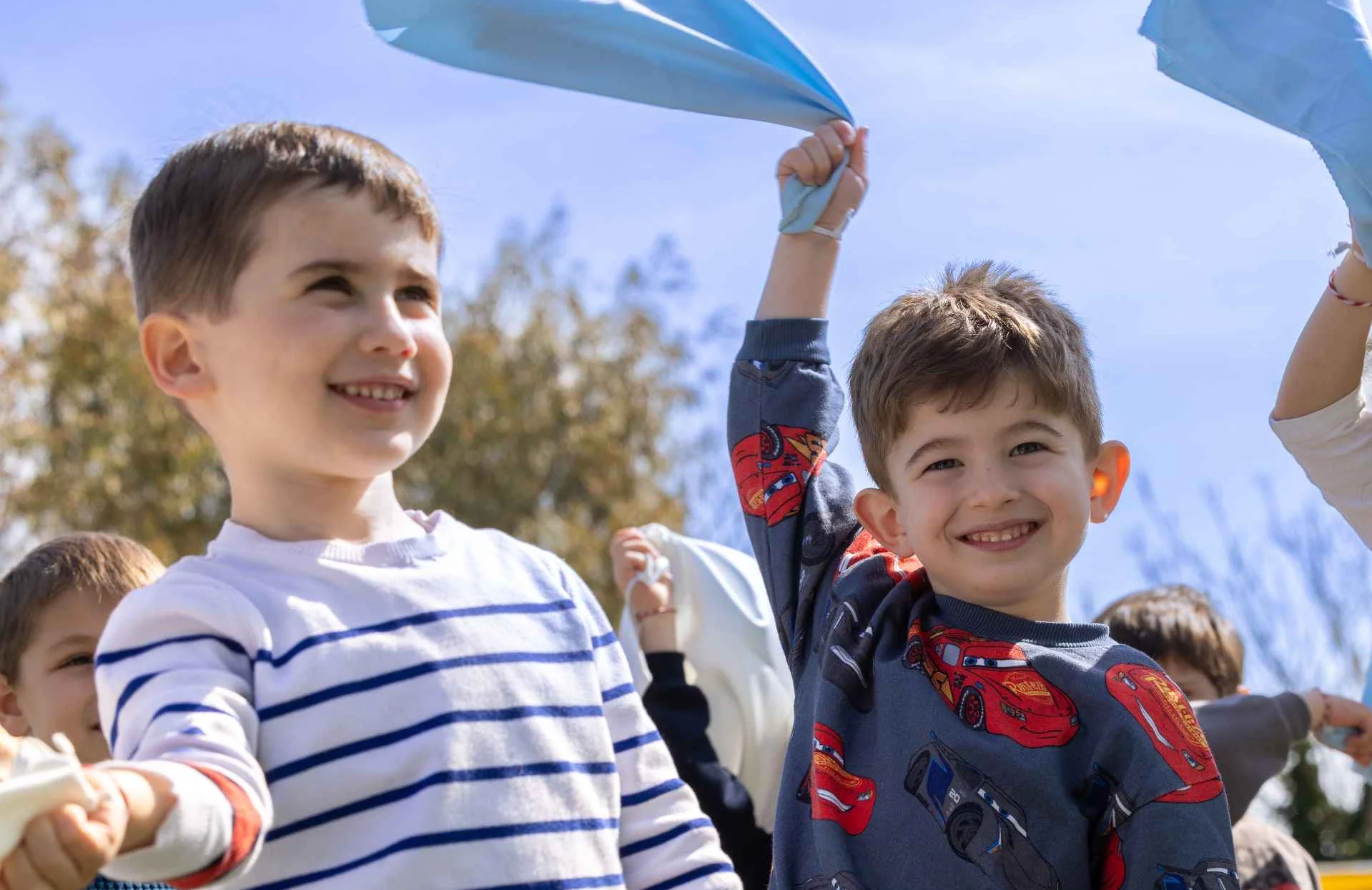 three kids playing and smiling