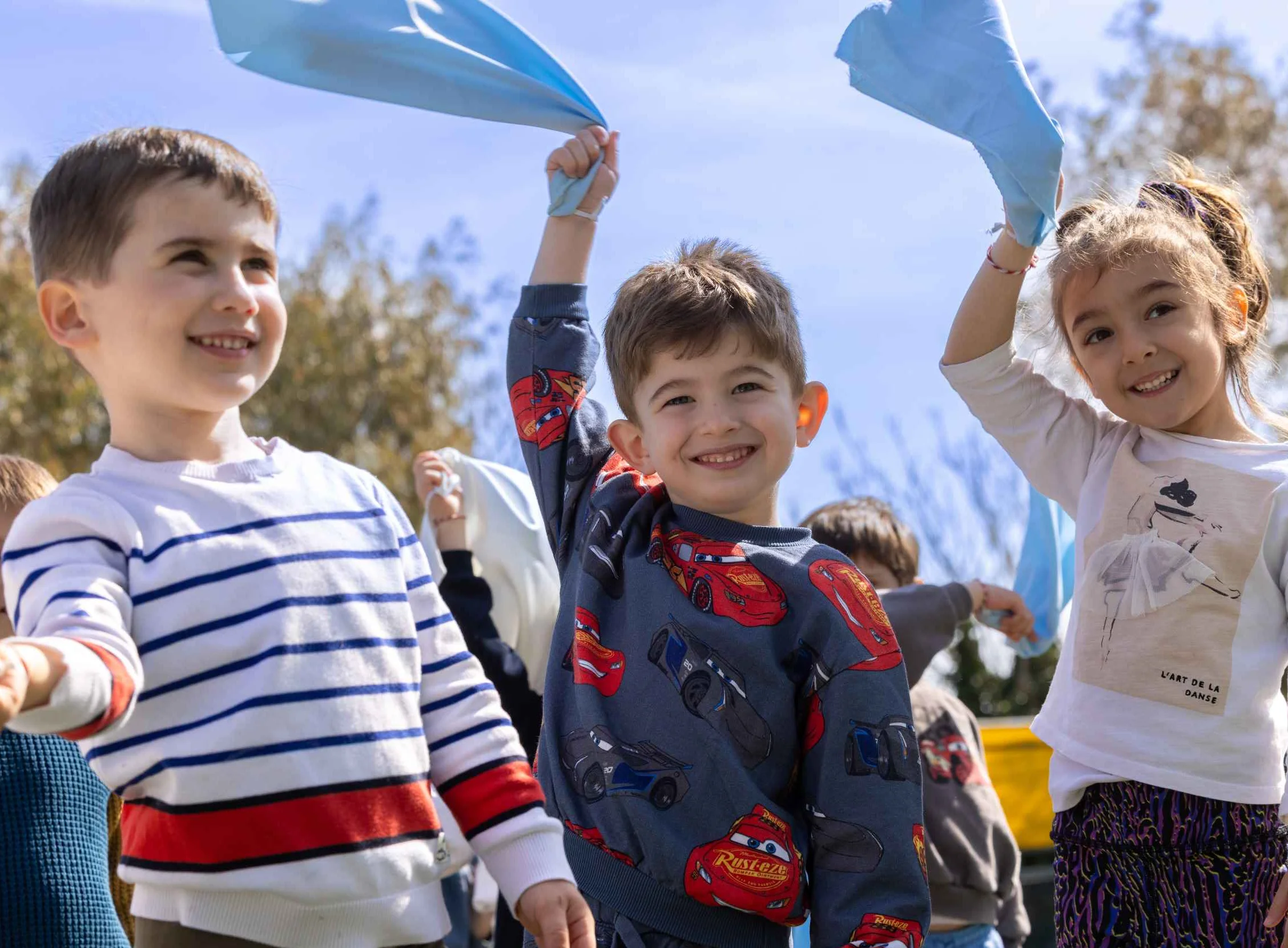 three kids playing and smiling
